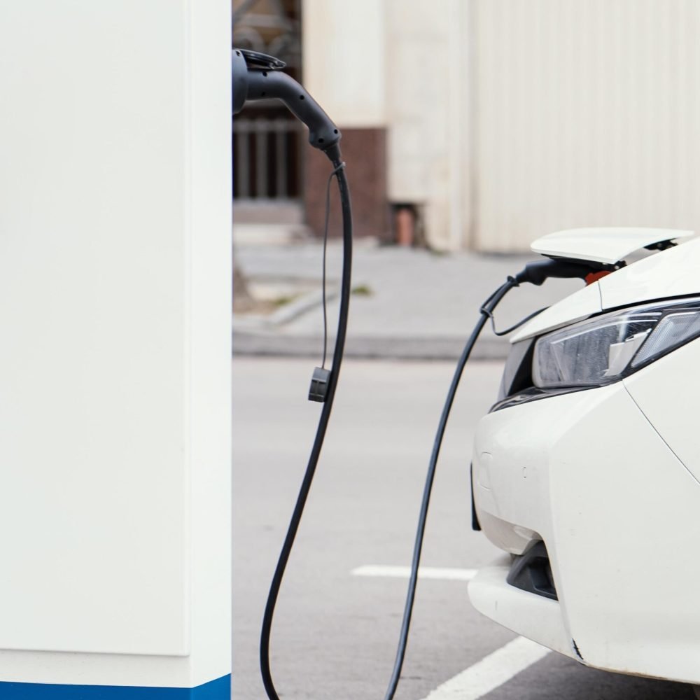 side-view-car-being-charged-electric-vehicle-charging-station-scaled